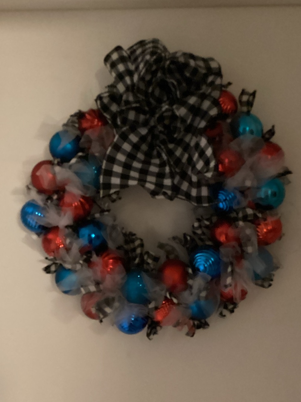Brand new homemade Christmas wreath with blue and red balls and black-and-white